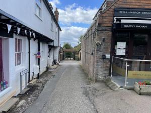 an alleyway between two buildings in a small town at The Greig 2 in Wadhurst