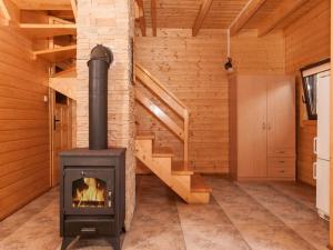 a wood stove in a room with a staircase at Holiday Resort in Pobierowo for 6 persons in Pobierowo