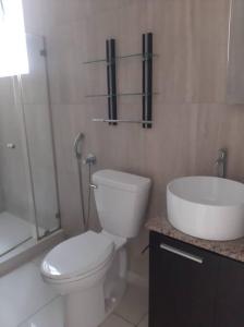 a white bathroom with a toilet and a sink at 5A - Boutique Apartment ! High end furnished! 4BR in Panama City