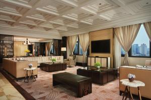 a living room with a couch and a television at Conrad Tianjin in Tianjin