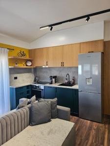 a kitchen with a couch and a refrigerator at Drion Apartment with lake view in Pogradec