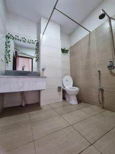 uma casa de banho com um lavatório, um WC e um espelho. em Three Bed Attached Bath Netflix Wifi Smart TV Parking WFH Desk Near Airport em Islamabad