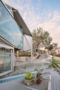 a house with glass walls and a patio at Luxury Villa Cañadas in Guadalajara