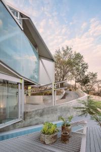 a house with glass walls and a patio at Luxury Villa Cañadas in Guadalajara +48 photos