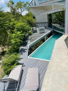 a house with a swimming pool and two chairs at Luxury Villa Cañadas in Guadalajara
