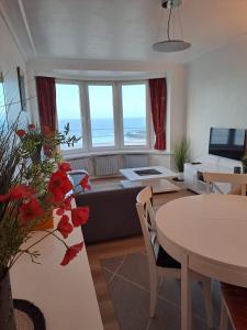 a living room with a couch and a table at Appartement met prachtig zicht op zee in Ostend