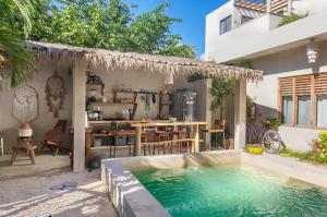 a swimming pool in the backyard of a house at Hostal Doña Lucha in Tulum