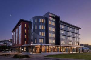 a large glass building with a building at Hilton Garden Inn Albany, WA in Albany