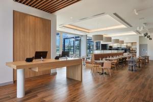 an office with a desk and tables and chairs at Hilton Garden Inn Albany, WA in Albany