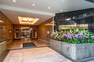 a lobby of a hotel with flowers in a planter at Conrad Bangkok Residences in Bangkok