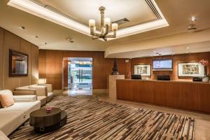 a lobby of a hotel with a waiting room at Conrad Bangkok Residences in Bangkok