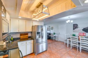 a kitchen with a stainless steel refrigerator and a table at Lake Havasu Vacation Home Private Pool and Hot Tub! in Lake Havasu City