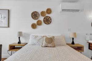 a bedroom with a white bed with a pillow on it at Cozy Kingsville Country Home Guest House in Kingsville