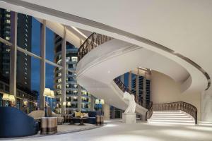 a spiral staircase in a building with buildings at Waldorf Astoria Bangkok in Bangkok