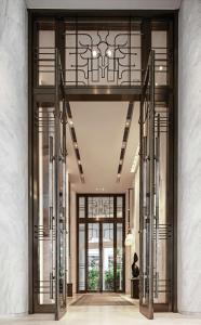 an entrance to a building with glass doors at Waldorf Astoria Bangkok in Bangkok