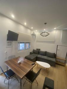 a living room with a table and a couch at Little Home in Potos