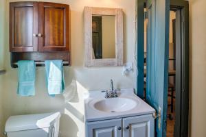 a bathroom with a sink and a toilet and a mirror at Downtown Montrose Apartment, 12 Mi to Natl Park! in Montrose +16 photos