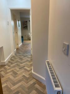 a hallway with a wooden floor in a house at Fabulous Flat close to Town & Countryside, Matlock in Matlock