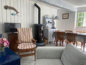 a living room with a couch and a table with a stove at La Petite Fanny in Étretat