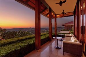 an outdoor patio with a view of a sunset at Hilton Goa Resort Candolim in Candolim