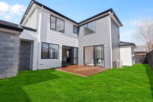 a house with a large yard with green grass at New 3bds house walk to Rototuna shopping Centre in Hamilton