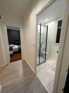 a bathroom with a glass door leading to a bedroom at Appartement entier proche de Paris. in Pavillons-sous-Bois