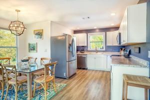 a kitchen with a table and chairs and a refrigerator at Henderson home in Sanibel