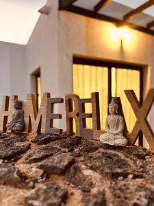 two buddha statues sitting on top of a house at Casa Relax in Playa Blanca