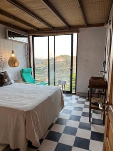 a bedroom with a bed and a checkered floor at El castillo de la Mora in Bédar