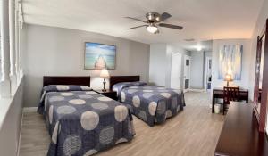 a bedroom with two beds and a ceiling fan at Sails Resort Motel in St. Pete Beach +86 photos