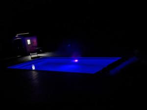 a pool table in a dark room with at Climatisé, piscine chauffée et parking fermé in Brignac-la-Plaine