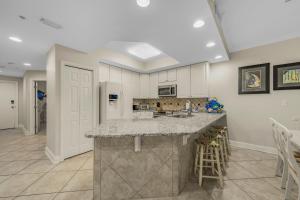 a kitchen with white cabinets and a counter top at San Carlos 1604 by Vacation Homes Collection in Gulf Shores