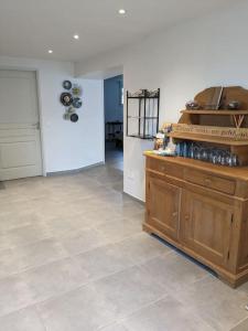 a kitchen with a counter and a tile floor at Climatisé, piscine chauffée et parking fermé in Brignac-la-Plaine