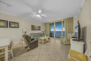 a living room with a couch and a tv at San Carlos 1604 by Vacation Homes Collection in Gulf Shores