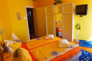 A bed or beds in a room at Caty Vendégház