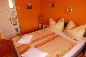 A bed or beds in a room at Caty Vendégház