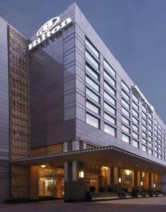 a building with a sign on the front of it at Hilton Chennai in Chennai
