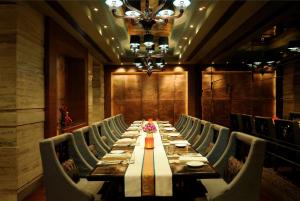 a long dining room with a long table and chairs at Hilton Chennai in Chennai