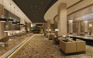 a lobby of a hotel with chairs and tables at Hilton Chennai in Chennai