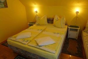 A bed or beds in a room at Caty Vendégház