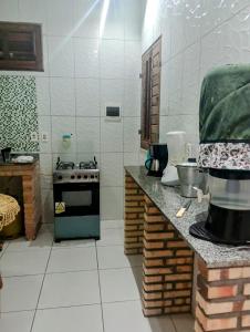 a kitchen with a stove and a counter top at Casa em Paracuru Beach in Paracuru