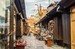 a street in an old town with shops at Swiss Central Luxury Apartment 132m2 in Sarajevo