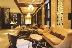 a lobby with couches and chairs and tables at DoubleTree by Hilton Hotel Naha in Naha