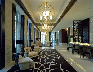 a lobby with couches and chairs and a chandelier at DoubleTree by Hilton Hotel Naha in Naha