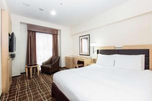 Postel nebo postele na pokoji v ubytování DoubleTree by Hilton Naha