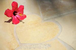 a red flower on the floor with a heart at DoubleTree by Hilton Hotel Naha Shuri Castle in Naha