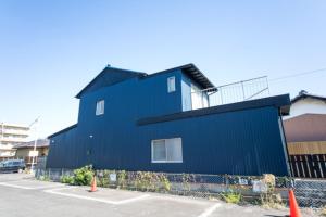 a blue building in a parking lot at Yokkaichi - House - Vacation STAY 68045v in Yokkaichi