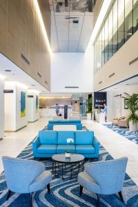 a lobby with blue chairs and a table at Hilton Surfers Paradise Hotel & Residences in Gold Coast +181 photos
