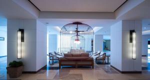 a lobby with a table and chairs and a bird cage at DoubleTree Resort by Hilton Hotel Penang in Batu Ferringhi
