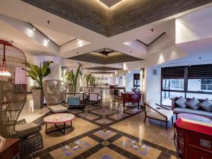 a living room with a couch and chairs and a table at DoubleTree Resort by Hilton Hotel Penang in Batu Ferringhi